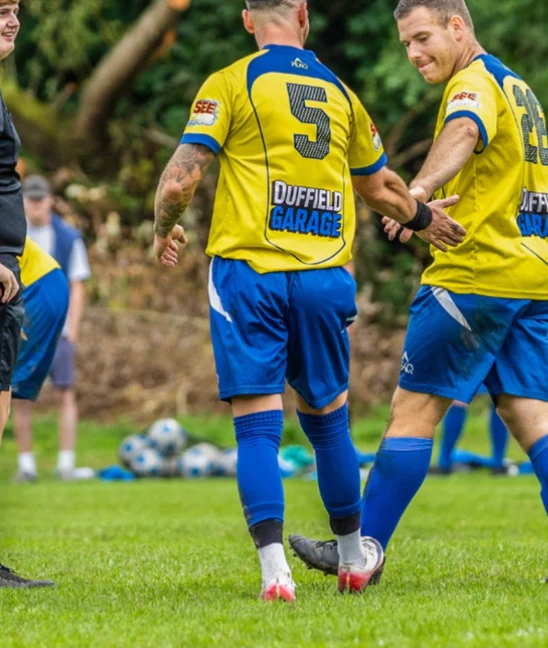 Two Codnor players celebrating, Duffield Garage on the back of the shirt